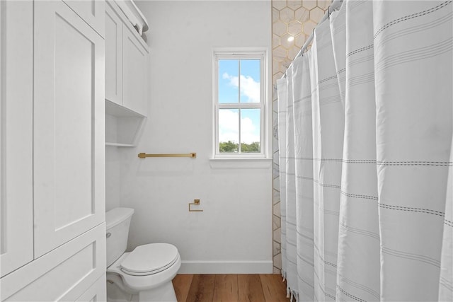 bathroom with hardwood / wood-style floors and toilet