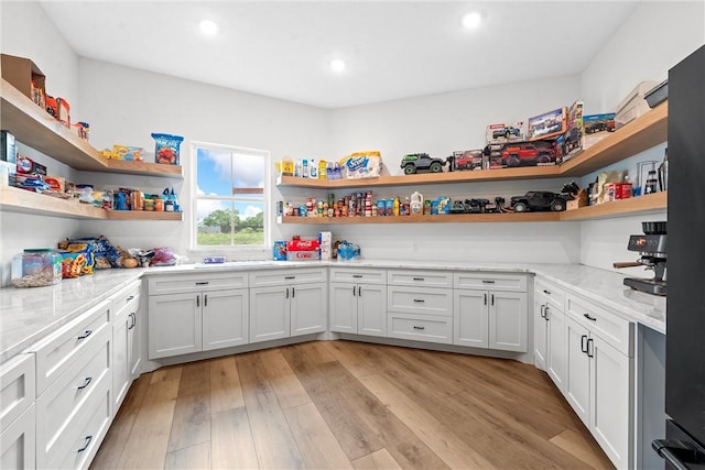 laundry area featuring light wood-type flooring