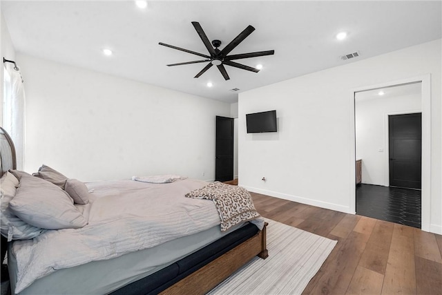 bedroom featuring ceiling fan and dark hardwood / wood-style floors