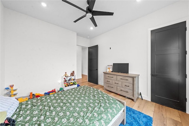 bedroom with ceiling fan and light hardwood / wood-style flooring