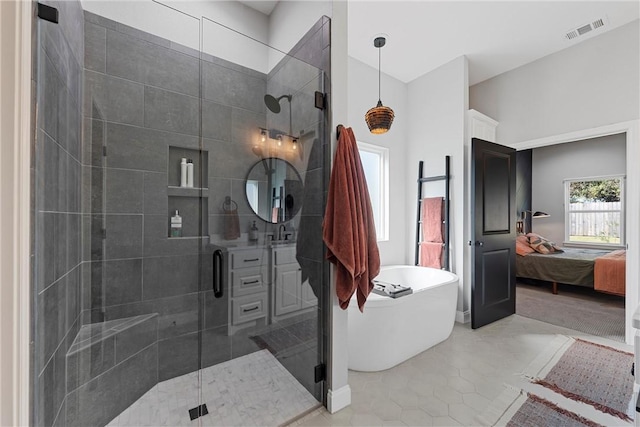 bathroom with tile patterned flooring, sink, and plus walk in shower