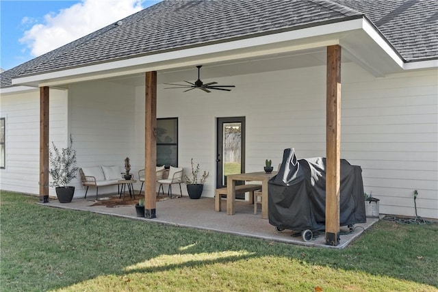 rear view of property with a yard, ceiling fan, and a patio area