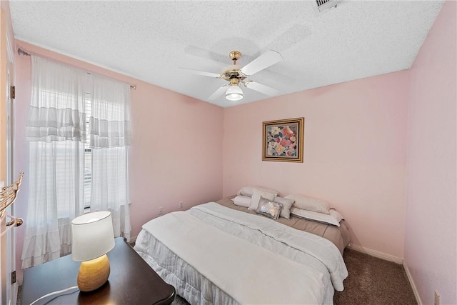 bedroom with carpet flooring, ceiling fan, and a textured ceiling