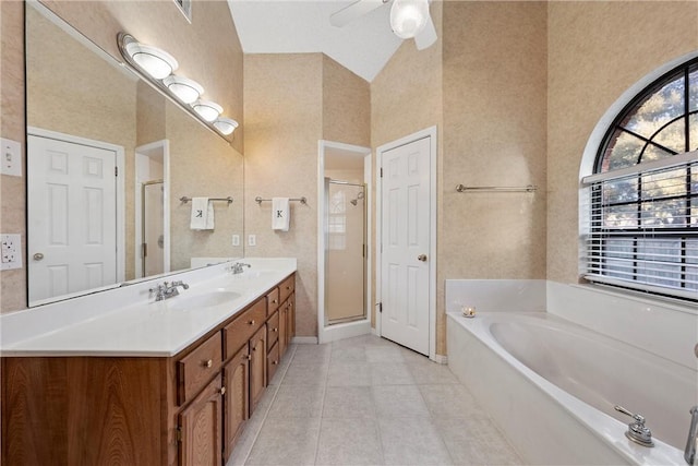 bathroom featuring tile patterned flooring, vanity, vaulted ceiling, and independent shower and bath