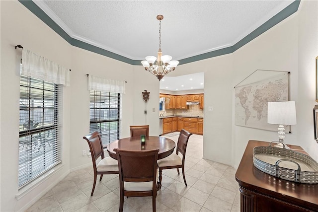 dining room with light tile patterned floors, a textured ceiling, crown molding, and a notable chandelier