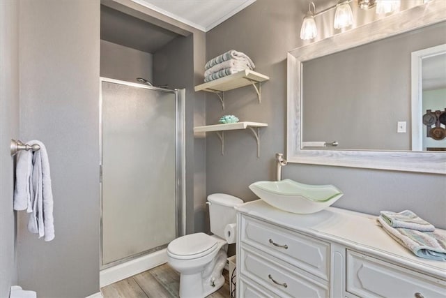 full bath with toilet, a stall shower, wood finished floors, and vanity