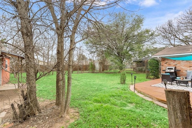 view of yard with a deck and fence