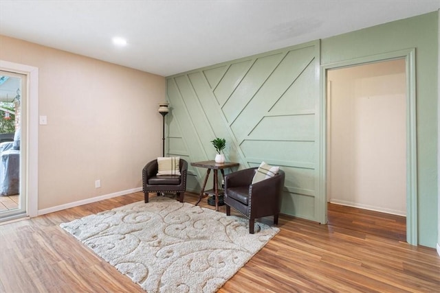 living area featuring wood finished floors and baseboards