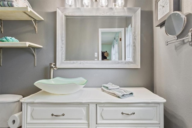 bathroom with toilet and vanity