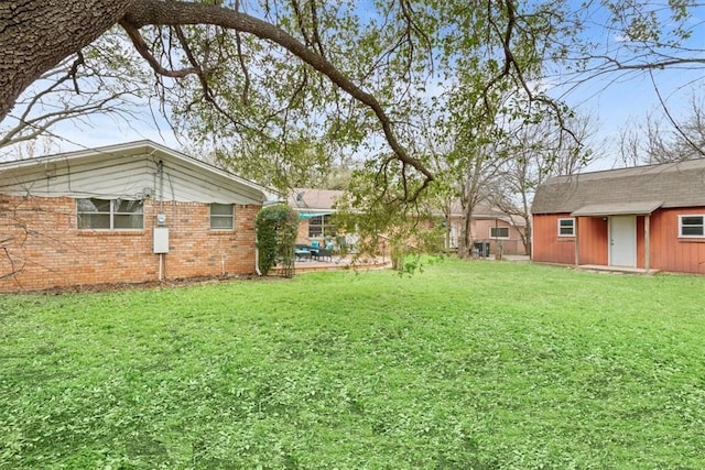 view of yard with an outbuilding and a patio