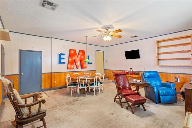 rec room featuring ceiling fan, carpet floors, wainscoting, and visible vents