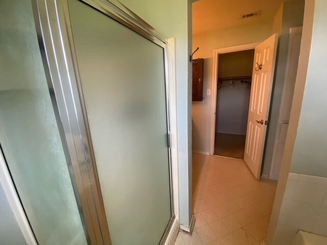 bathroom with a shower with door