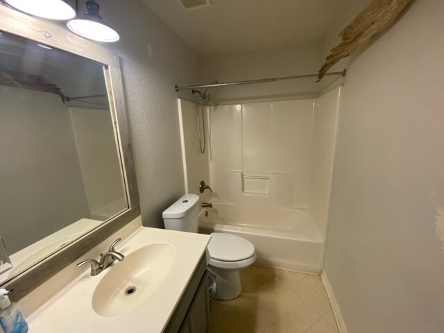 full bathroom with vanity, toilet, and shower / washtub combination