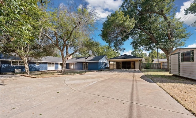 ranch-style house featuring a carport