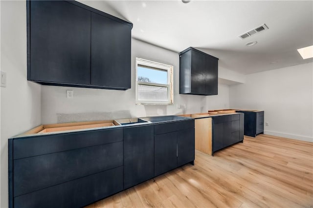 kitchen with wooden counters and light hardwood / wood-style floors