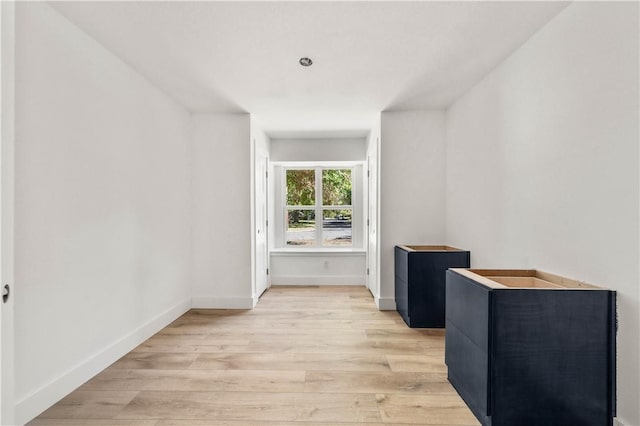 hallway with light hardwood / wood-style flooring