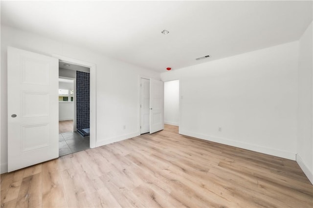 unfurnished bedroom featuring light wood-type flooring