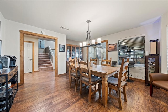 dining room featuring hardwood / wood-style floors and a notable chandelier