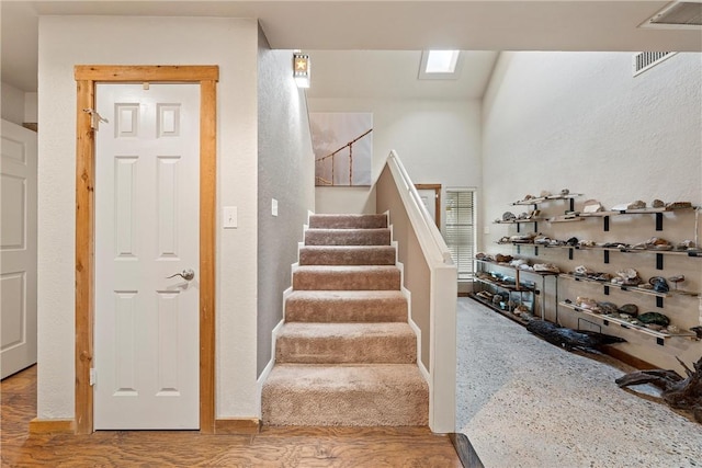 staircase featuring wood-type flooring