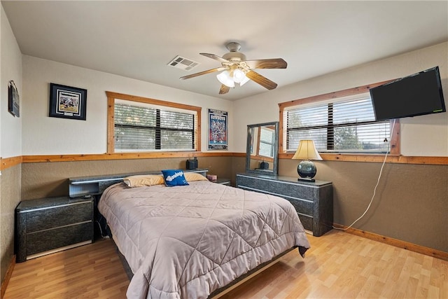 bedroom with ceiling fan and light hardwood / wood-style flooring