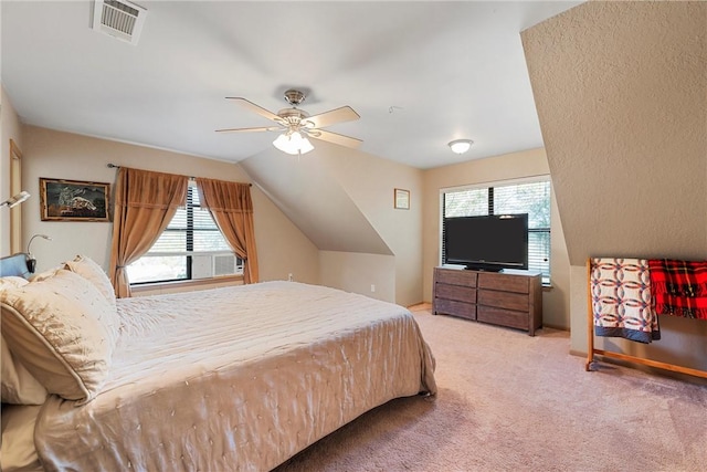 carpeted bedroom with ceiling fan, lofted ceiling, and multiple windows