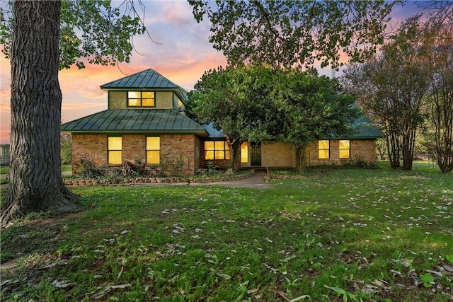 view of front of house with a yard