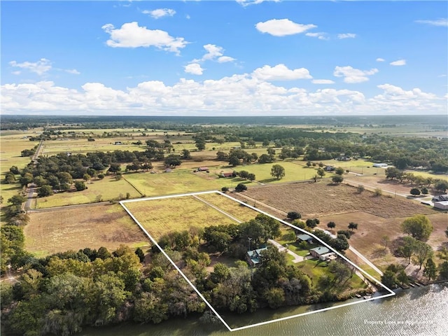 drone / aerial view featuring a rural view and a water view