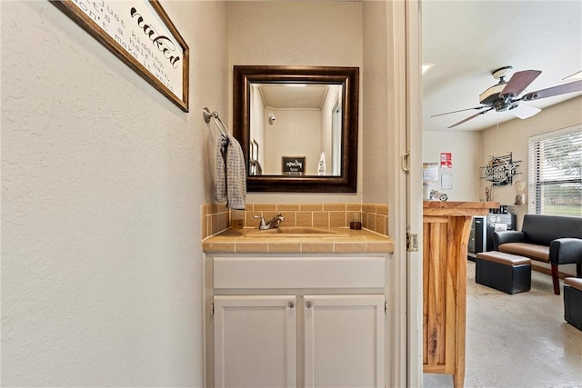 bathroom featuring ceiling fan, vanity, and concrete flooring