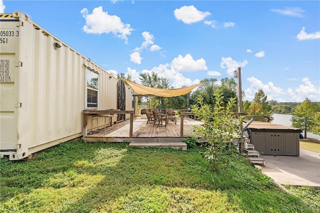 view of yard featuring a deck and a jacuzzi