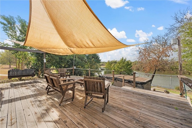 wooden deck featuring a water view