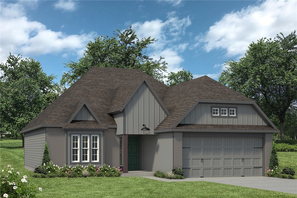 view of front of home featuring a garage and a front yard