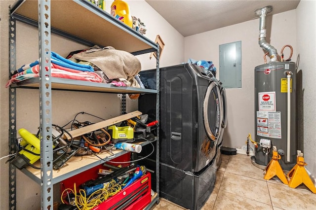 clothes washing area featuring separate washer and dryer, electric panel, gas water heater, and tile patterned floors