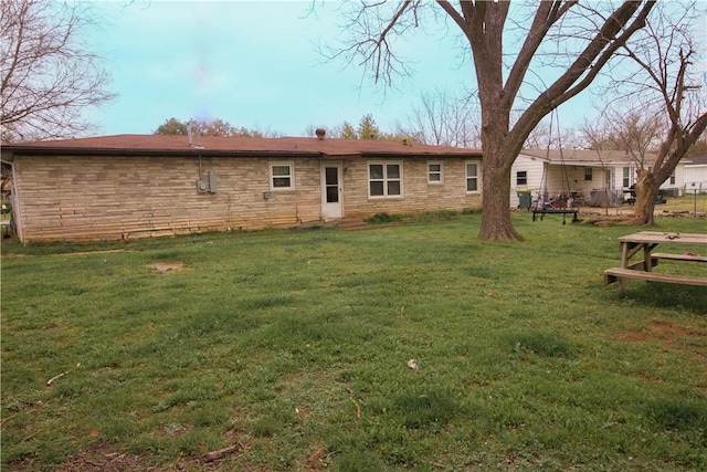 back of house featuring a lawn