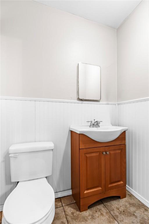 bathroom with tile patterned floors, vanity, and toilet