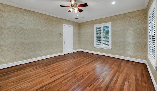 empty room featuring hardwood / wood-style floors, ceiling fan, and crown molding