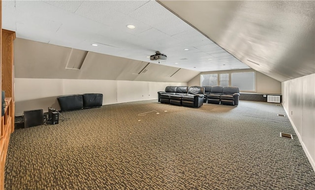 carpeted cinema featuring ceiling fan and vaulted ceiling