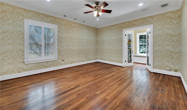 unfurnished room with crown molding, ceiling fan, and wood-type flooring