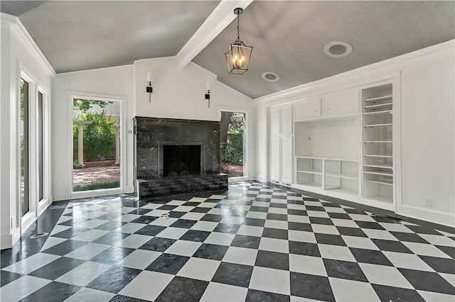 unfurnished living room with vaulted ceiling with beams, a premium fireplace, and a chandelier