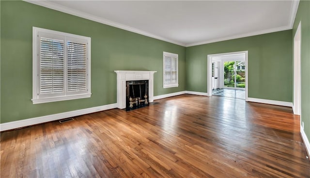 unfurnished living room with crown molding and hardwood / wood-style flooring