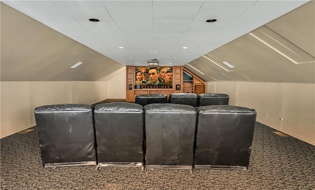 cinema featuring dark carpet and vaulted ceiling