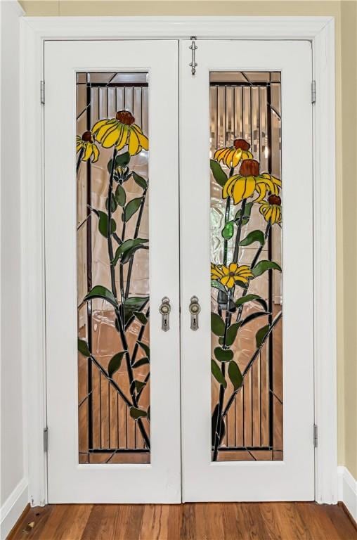 interior details featuring french doors and wood-type flooring