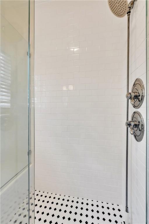 bathroom featuring a shower with door