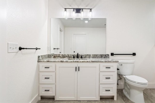 bathroom with toilet and vanity