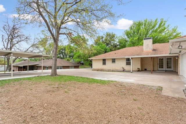 back of house with a carport