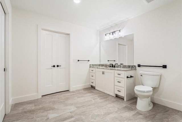 bathroom featuring toilet and vanity