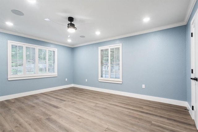 empty room featuring ceiling fan, crown molding, and light hardwood / wood-style flooring