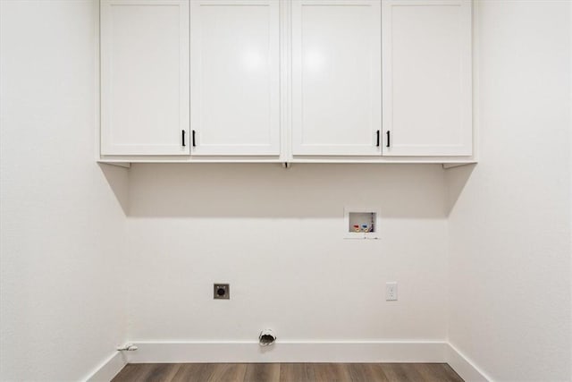 laundry room featuring dark hardwood / wood-style floors, hookup for an electric dryer, hookup for a washing machine, and cabinets