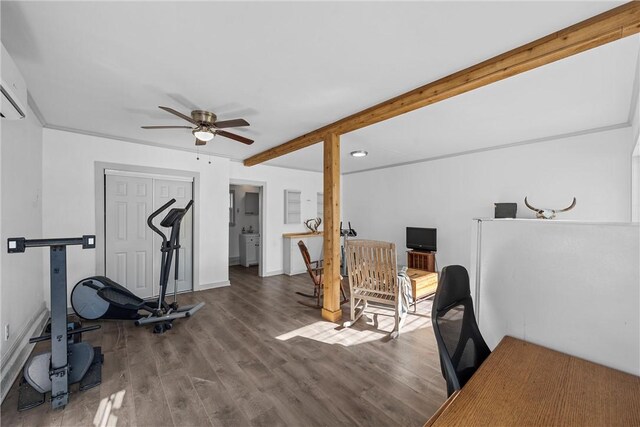 workout area featuring a ceiling fan, wood finished floors, and baseboards