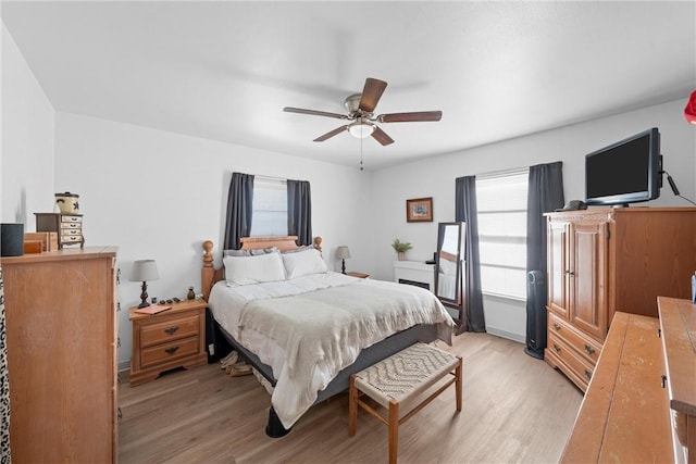 bedroom with a ceiling fan and light wood finished floors