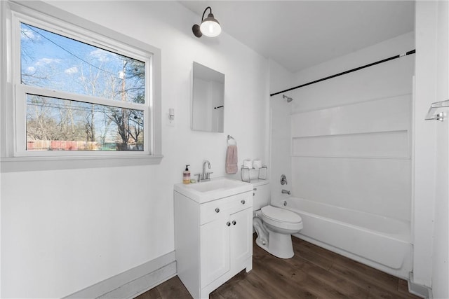 bathroom featuring vanity, toilet, shower / bathing tub combination, and wood finished floors